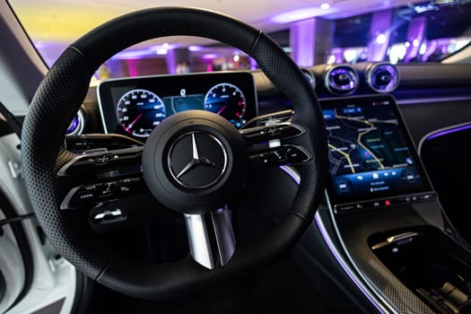 Kyiv, Ukraine - September 12: Mercedes-Benz luxury car interior showcasing the sleek design of the steering wheel, digital dashboard, and advanced navigation system