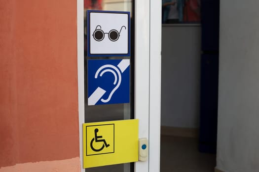 Signs for deaf people and for blind people with disabilities. Accessible environment for people with disabilities on the face of the city, assistance before entering the building for elderly people
