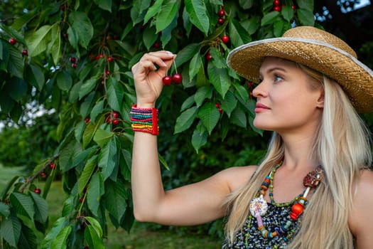In the midst of a lush cherry orchard stands a radiant scene: a woman adorned in vibrant attire, meticulously plucking cherries from laden branches. With sun-kissed blonde hair cascading from beneath her straw hat, she exudes an aura of summertime splendor. Her attire is a delightful kaleidoscope of hues, accentuated by a colorful necklace draped gracefully around her neck and a matching bracelet adorning her wrist. In one hand, she delicately cradles two ripe cherries, their crimson skins glistening in the warm sunlight. Behind her, the cherry tree bows under the weight of its bountiful harvest, each branch adorned with clusters of luscious, ruby-red fruit. Woman tranquilly stare at cherries, her eyes reflecting the tranquility of the idyllic orchard scene. Amidst nature's abundance, she embodies the essence of summertime bliss, a picturesque moment captured in the heart of the cherry season