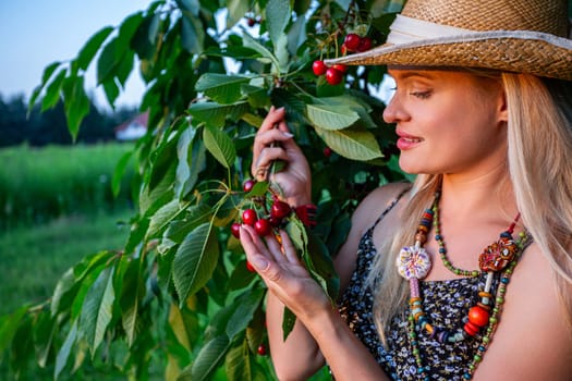 During the summer sunset, a beautiful woman with blonde hair stands amidst the tranquil beauty of a cherry orchard. Delicately, she holds a branch of the cherry tree in one hand, while in the other, she cradles a handful of ripe cherries. Her charming smile radiates delight as she gazes upon the fruits of her labor, each cherry ripe, red, and glistening in the fading light. She has straw hat, summer dress and colorful necklace. As the sun dips below the horizon, casting a warm golden glow over the landscape, the woman's serene expression mirrors the tranquility of the evening. Her blonde locks frame her face, accentuating her natural beauty, which harmonizes perfectly with the idyllic surroundings. In this moment of quiet contemplation, surrounded by the warm hues of the summer evening, the woman finds solace and joy in the simple pleasures of life. Her connection to the earth and the cycle of life is palpable, as she embraces the abundance of nature's blessings with gratitude and reverence. With her charming smile and expression of enchantment, the woman embodies the harmony between humanity and the natural world, celebrating the beauty and power of nature in all its splendor.