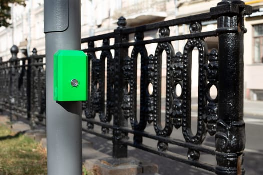 Button for changing the traffic light signal for pedestrians near the road to cross the street, modern convenient technologies for city life