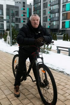 European elderly man doing sports and riding a bicycle.