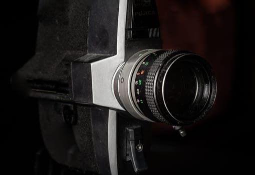 Bangkok, Thailand - 17 Sep, 2024 - Close-up of Old movie camera 8mm with black background. Light and Shadow, Copy space, Selective focus.