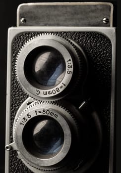 Bangkok, Thailand - 17 Sep, 2024 - Close-up of Old two lens medium format film camera or Vintage twin lens reflex photo camera. An idea of old camera and memory, Light and Shadow, Selective focus.