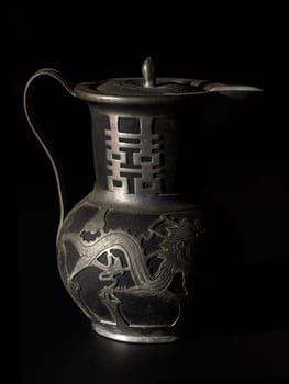 Bangkok, Thailand - 18 Sep, 2024 - Chinese traditional teapot with dragon pattern and chinese characther double (Translation meaning is Double Happiness). Antique metal teapot usually it use For Chinese tea ceremony during wedding day. Light and Shadow, Space for text, Selective focus.