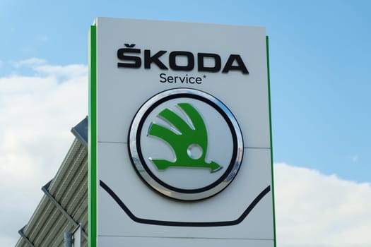Tyumen, Russia-August 10, 2024: Skoda service center sign against a cloudy sky in a busy automotive district
