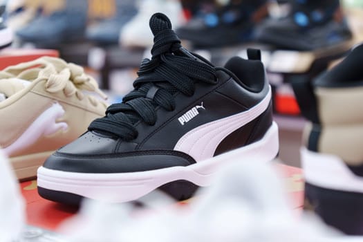 Tyumen, Russia-August 11, 2024: Stylish athletic shoe Puma displayed in a retail store with a modern design and vibrant colors