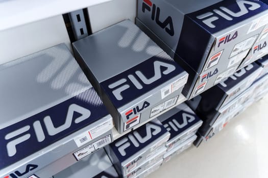 Tyumen, Russia-August 11, 2024: Fila sneaker is prominently displayed with detailed lacing and a visible brand tag, viewed inside a retail shop.