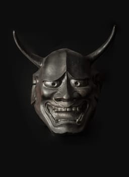 Bangkok, Thailand - 19 Sep, 2024 - Traditional japanese mask of a demon on black background. The mask shadow kabuki is a classical japanese dance drama with theater form, Light and Shadow, Space for text. Selective Focus.