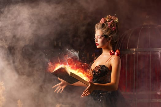 Woman witch in vintage black dress with book of spell in old castle. Halloween. Celebration. Witchcraft concept, fairy tale mystic atmosphere. Conjure magic spells.