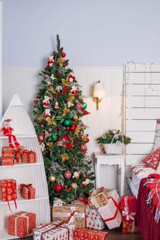 Interior of festive bedroom with comfortable bed and Christmas tree