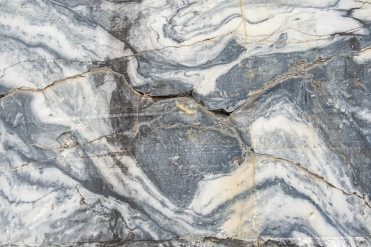 A stunning surface of gray marble exhibits intricate white veining and natural patterns, showcasing the beauty of this stone in a decorative context.