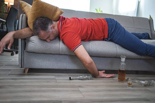 Drunk man sleeping on a sofa.