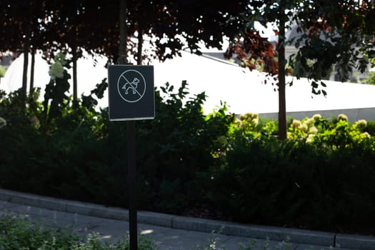 Sign prohibiting dogs from walking in park, decorative public park prohibiting dogs from walking on territory, cleanliness and care for plants in the park