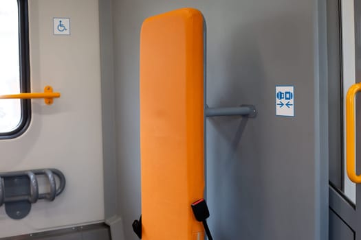 Backrest for fixing and controlling child stroller or wheelchair while traveling on train, fixation for person with disabilities, safe place for disabled people with anchorage for convenient movement