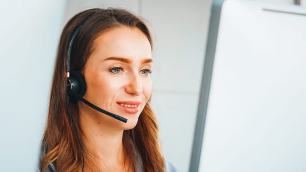 Business people wearing headset working in office to support remote customer or colleague. Call center, telemarketing, customer support agent provide service on telephone video conference call. Jivy