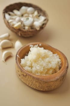 close up of minced garlic on a wooden spoon ,