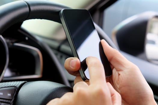 image of using a mobile phone inside of a car