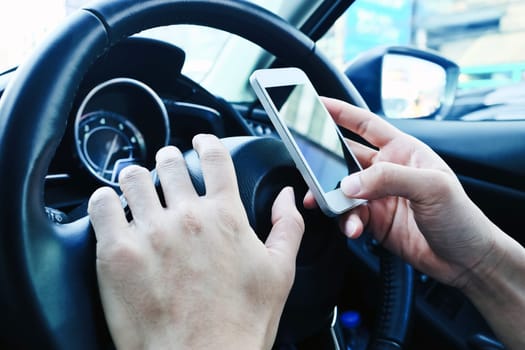 image of using a mobile phone inside of a car