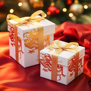 A white gift box with an image of a dragon tied with a yellow ribbon. High quality photo