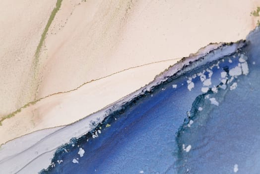 The tranquil beauty of ocean waves gracefully meeting sandy shores, featuring soft tones and fluid patterns in a watercolor medium.