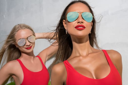 Sexy girls wearing bright swimsuits and glasses sunny photo