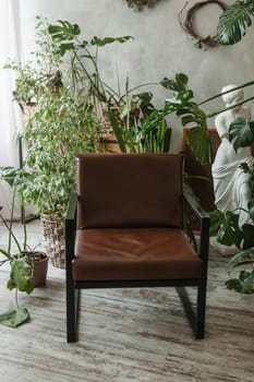 A fragment of the interior with a variety of indoor plants and plaster sculptures. Urban jungle concept. Biophilia design.