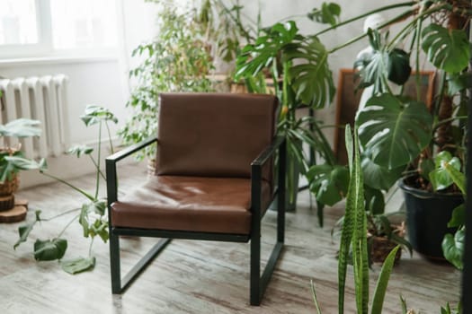 A fragment of the interior with a variety of indoor plants and plaster sculptures. Urban jungle concept. Biophilia design.