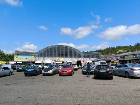 7 August 2024 Tskhaltubo Georgia, market and parking lot transport on the city square, Blue sky clouds summer season street town road car. High quality photo