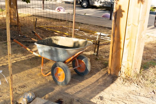 metal dirty wheel concrete tool site equipment construction background industrial cart wheelbarrow barrow