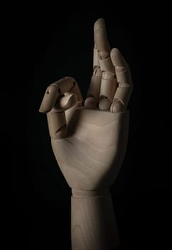 Wooden hand of mannequins showing OK gesture sign isolated on Black background. Positive concept, Wooden hand puppet, Showing, Symbol, Banner design, Gesture and sign, Space for text, Selective focus.