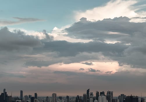 Bangkok, Thailand - 04 Aug 2024 - Aerial view of skyscrapers and dramatic sky before sunset. Beautiful clouds in the sky over large metropolitan city of bangkok, Copy space, Selective focus.