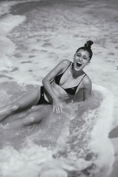 A truly joyful and unforgettable moment on the sandy beach, where laughter seamlessly meets the refreshing ocean waves
