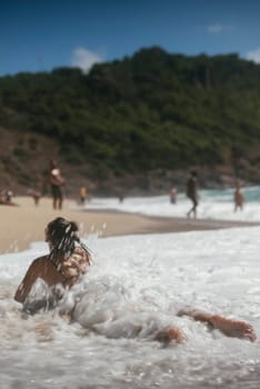 It is a remarkably beautiful day spent at the beach, with activities like sunbathing and gentle waves rolling in