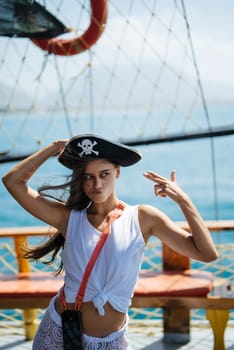 A vibrant piratethemed photoshoot of a woman confidently posing on deck with a stunning sea backdrop