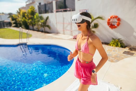 A woman enjoys a peaceful moment at the pool, fully immersed in an exciting and thrilling virtual reality experience