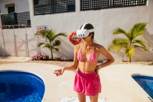 A woman wearing stylish VR goggles stands confidently next to the pool, showcasing vibrant fun summer tech vibes