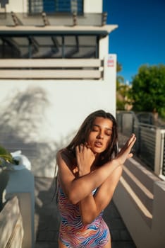 This is a stunning and vibrant poolside portrait that beautifully captures the essence of summer elegance and style