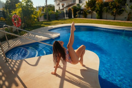 A young girl joyfully strikes a playful pose by the poolside, radiating vibrant summer vibes with happiness