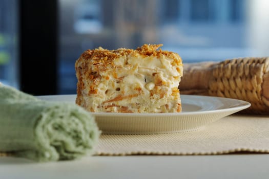 A beautifully crafted dessert roll sits elegantly on a plate, revealing layers of cream and sweet filling, complemented by a lively urban backdrop.