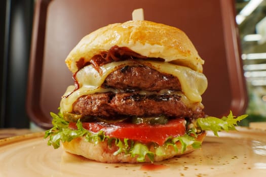 A mouthwatering burger is layered with fresh lettuce, ripe tomatoes, and melted cheese