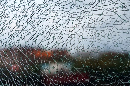 Delicate shards of broken glass create a mesmerizing texture, softening the view of a colorful
