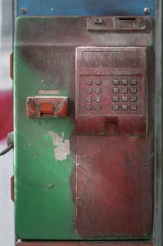 Abandoned vintage public coin operated public payphone. Old public service coin telephone in thailand that is no longer used due to technological advances, Copy space, Selective focus.