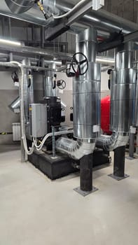 Pipes and water pressure and temperature sensors in basement of building. Providing communications for modern buildings, water pumping station