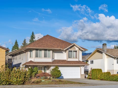 Big residential house on bright winter day in British Columbia.