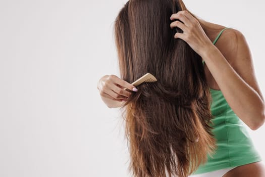 Beauty Hair Care. Beautiful Woman Combing Long Natural Hair, hair care, hair problem