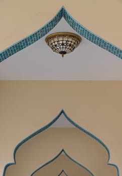 Bangkok, Thailand - May 28,2022 - Leading lines or curve of interior design elements with Ceiling lamp of Bang O mosque. Perspective architecture and art concept, Space for text, Selective focus.