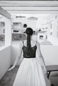 A graceful woman dressed in a flowing skirt is beautifully captured within a serene and calming monochrome setting