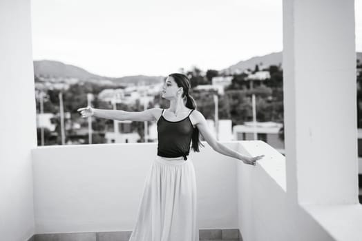 A beautifully serene capture of a graceful dancer in dynamic motion on a balcony, showcasing both elegance and beauty
