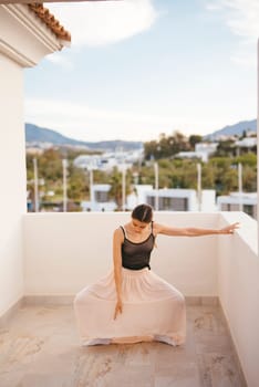A talented dancer elegantly performs and moves gracefully in a serene outdoor setting filled with beautiful mountains